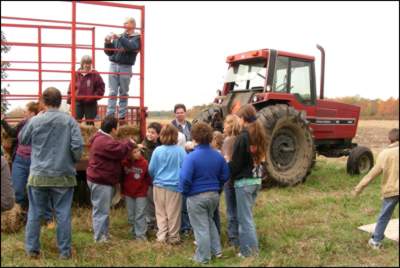 Chuck hooked tractor up to his hay wagon, loaded everyone in, and took us for a tour of Cranberry Hall Farm.