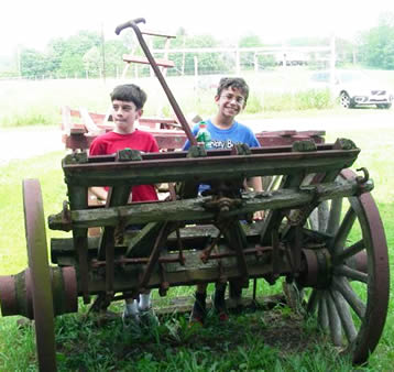Julian Librizzi and Joseph Kent on antique farm equipment. Julian Librizzi and Joseph Kent on antique farm equipment.